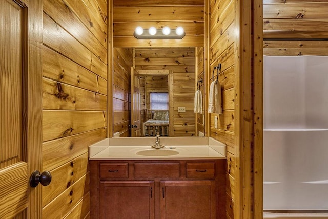 bathroom with vanity and wooden walls