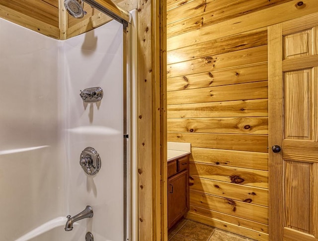 bathroom featuring vanity, shower / bathtub combination, and wooden walls