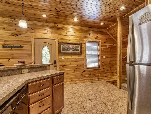 kitchen featuring stainless steel fridge, wooden walls, wooden ceiling, and decorative light fixtures