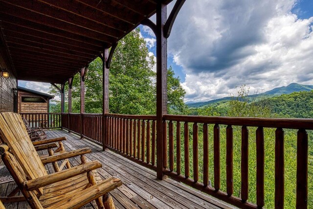 wooden deck with a mountain view