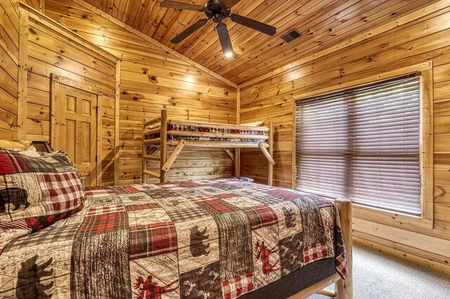 bedroom with ceiling fan, carpet floors, vaulted ceiling, wooden walls, and wood ceiling