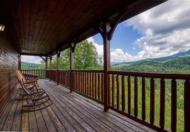 wooden terrace with a mountain view and covered porch