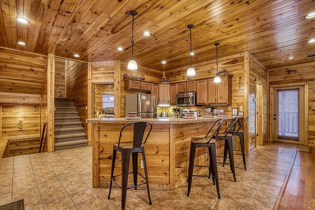 kitchen with kitchen peninsula, stainless steel appliances, hanging light fixtures, and wooden ceiling