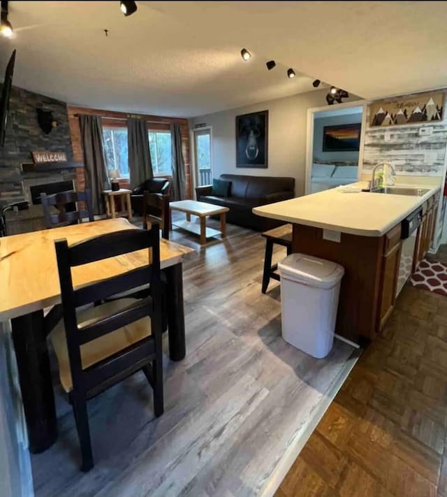 dining room with a stone fireplace and sink