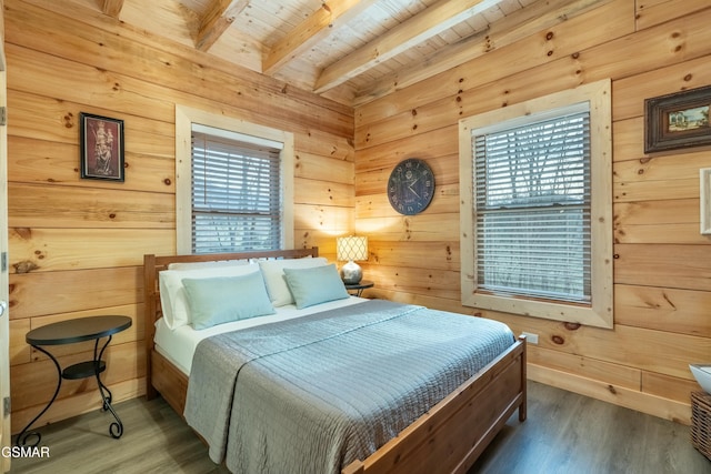 bedroom featuring beam ceiling, wooden ceiling, wood walls, and wood finished floors