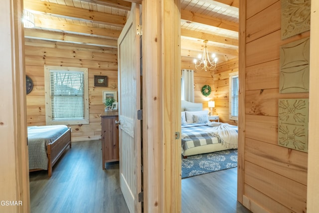 interior space featuring wood ceiling, wood finished floors, beam ceiling, wood walls, and a notable chandelier