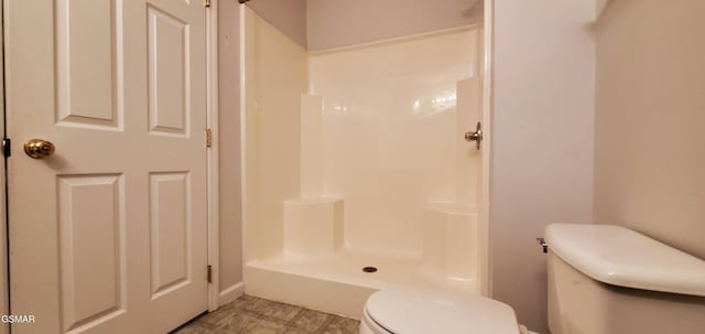 bathroom featuring toilet and walk in shower