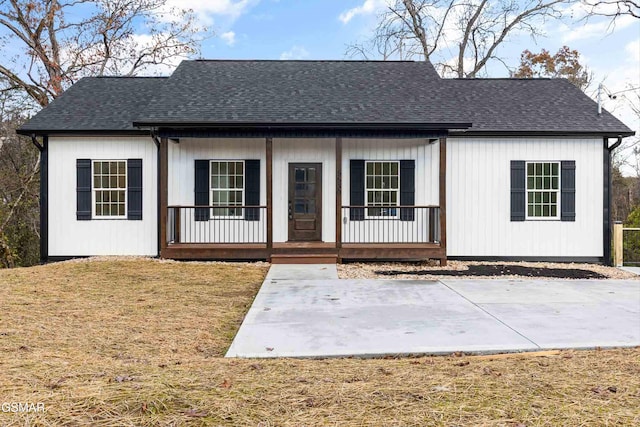 view of front of home with a porch and a front yard