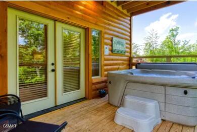 937 Pine Valley Way, Sevierville, TN 37862 - doorway to outside featuring log walls, wood finished floors, and french doors