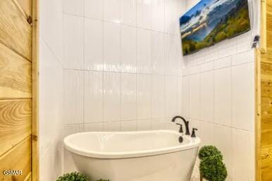 937 Pine Valley Way, Sevierville, TN 37862 - bathroom with tile walls and a freestanding tub