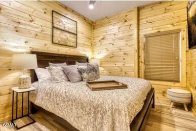 937 Pine Valley Way, Sevierville, TN 37862 - bedroom with wood finished floors and wooden walls
