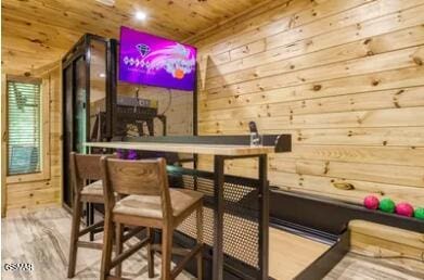 937 Pine Valley Way, Sevierville, TN 37862 - bar with wooden walls, wood ceiling, and wood finished floors