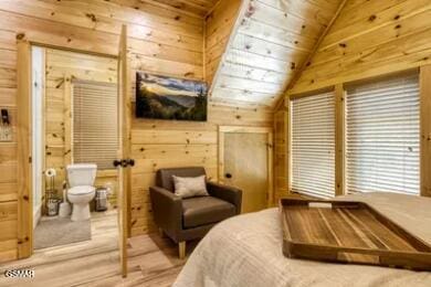937 Pine Valley Way, Sevierville, TN 37862 - bedroom featuring wooden walls, lofted ceiling, and ensuite bathroom