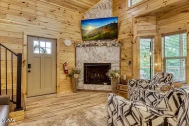 937 Pine Valley Way, Sevierville, TN 37862 - living area featuring wood walls, wood finished floors, a fireplace, high vaulted ceiling, and wooden ceiling