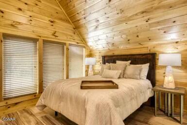 937 Pine Valley Way, Sevierville, TN 37862 - bedroom featuring vaulted ceiling, wood ceiling, wood walls, and wood finished floors