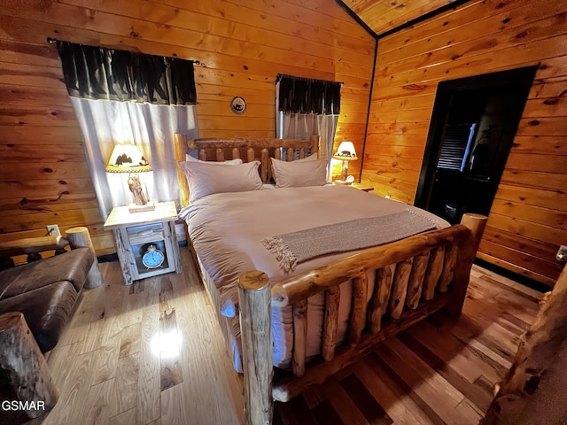 1156 Hemlock Dr, Gatlinburg, TN 37738 - bedroom with wood walls, lofted ceiling, and hardwood / wood-style floors