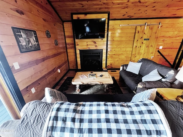 1156 Hemlock Dr, Gatlinburg, TN 37738 - living area featuring wooden walls, wood ceiling, a fireplace, lofted ceiling, and wood finished floors