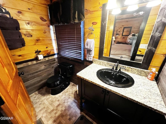 1156 Hemlock Dr, Gatlinburg, TN 37738 - bathroom with wooden walls, vanity, and toilet