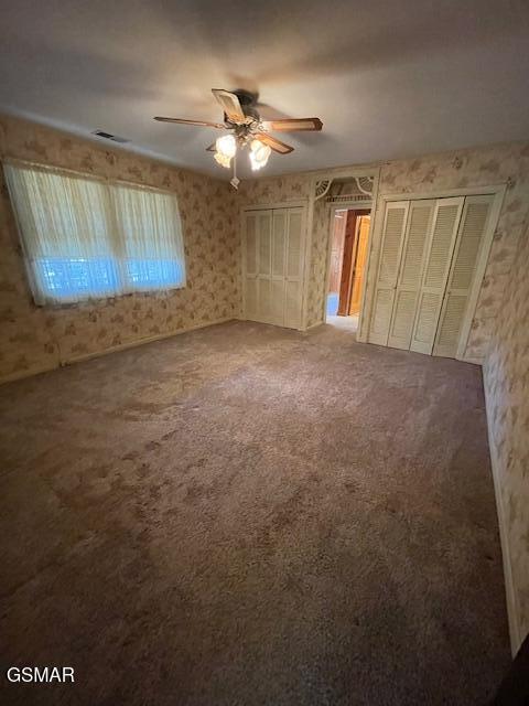 unfurnished bedroom with ceiling fan and carpet flooring