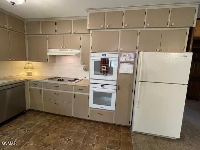 kitchen with decorative backsplash and white appliances