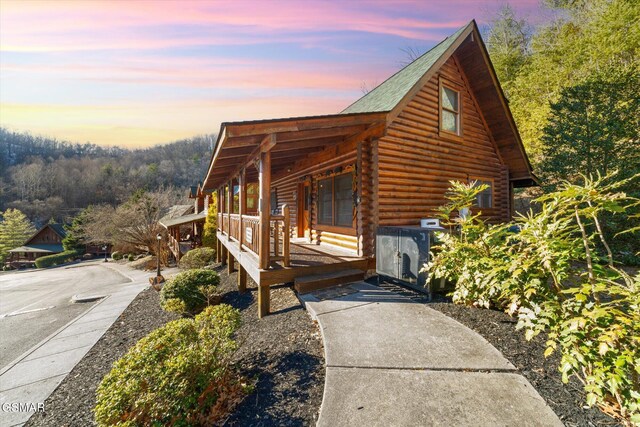 property exterior at dusk with covered porch