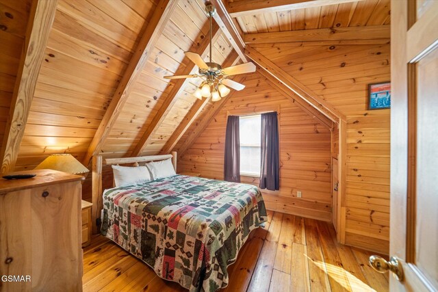 bedroom featuring wood ceiling, light hardwood / wood-style flooring, lofted ceiling with beams, and wood walls