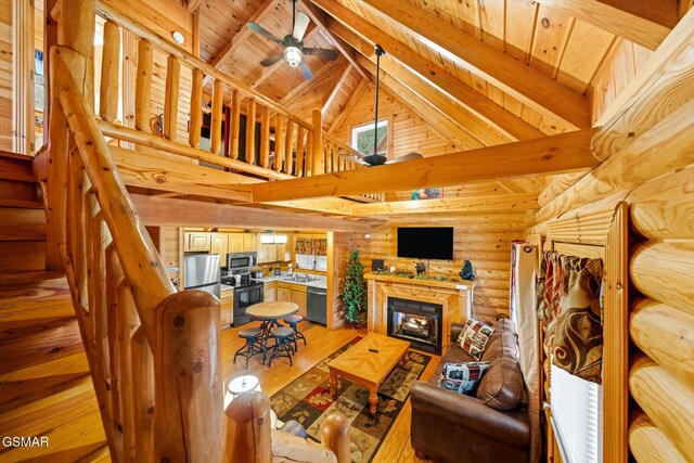 living room featuring high vaulted ceiling, sink, hardwood / wood-style flooring, wooden ceiling, and beam ceiling