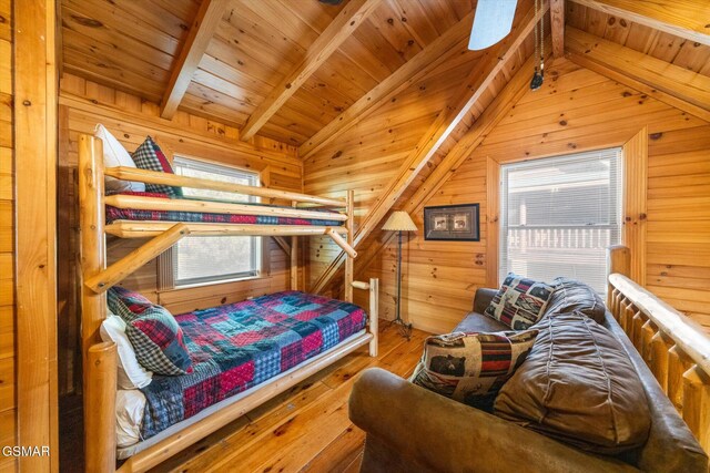 bedroom featuring vaulted ceiling with beams, hardwood / wood-style floors, wood ceiling, and wood walls