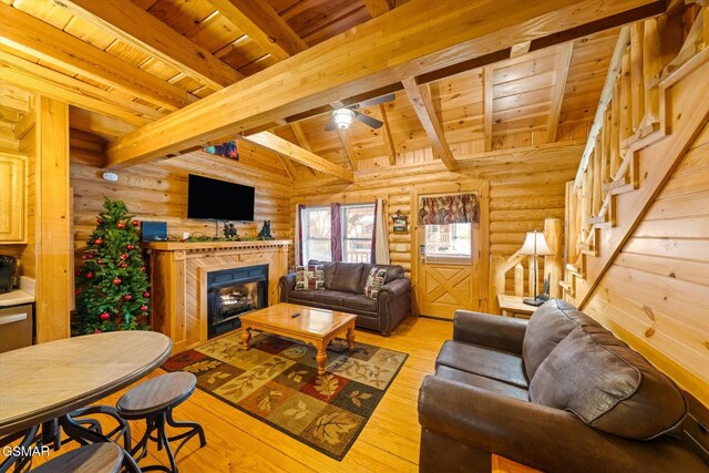 living room with beam ceiling, wood ceiling, ceiling fan, and light hardwood / wood-style flooring