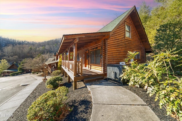 property exterior at dusk with a porch