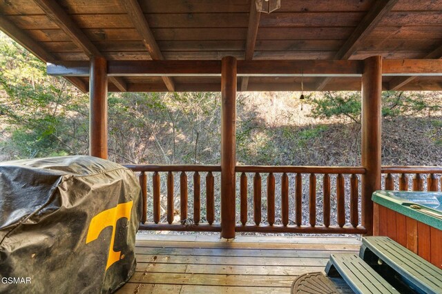 wooden terrace featuring a grill and a hot tub