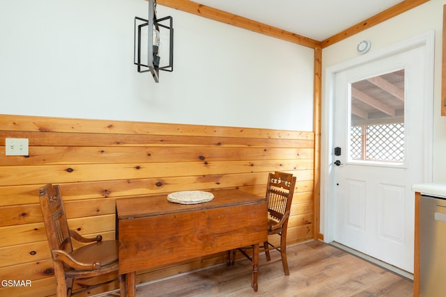 dining space featuring wooden walls and hardwood / wood-style floors