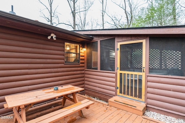 wooden deck with a sunroom