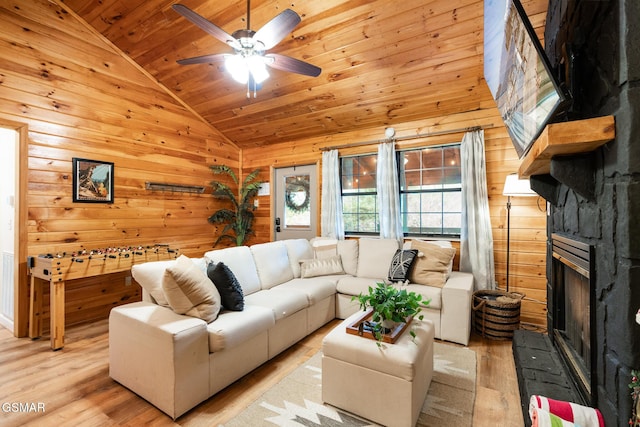 living room featuring light hardwood / wood-style flooring, ceiling fan, lofted ceiling, and wood ceiling