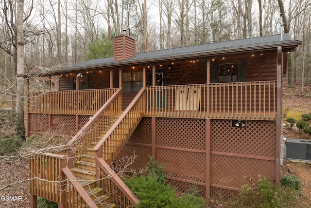 rear view of property featuring central AC unit