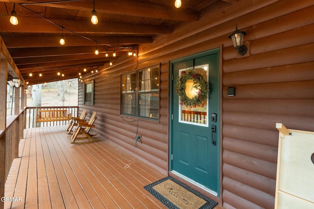 view of exterior entry with a porch