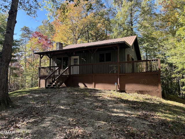 rear view of property with a wooden deck