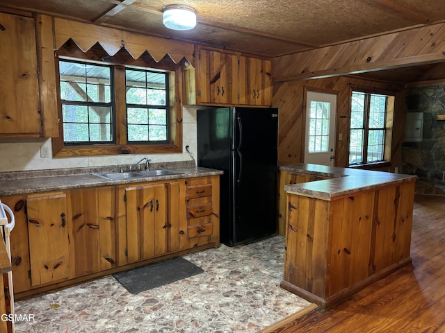 kitchen with a healthy amount of sunlight, black refrigerator, sink, and electric panel