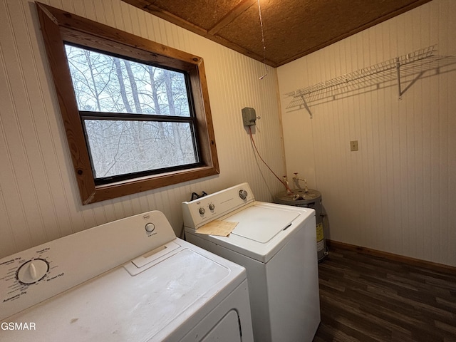 clothes washing area with washing machine and clothes dryer, wooden ceiling, wooden walls, dark hardwood / wood-style floors, and electric water heater