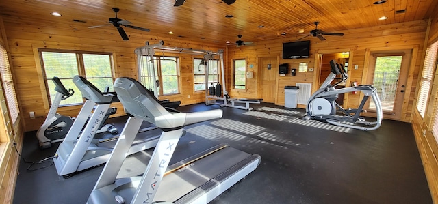 workout area featuring wood walls, wood ceiling, and a ceiling fan