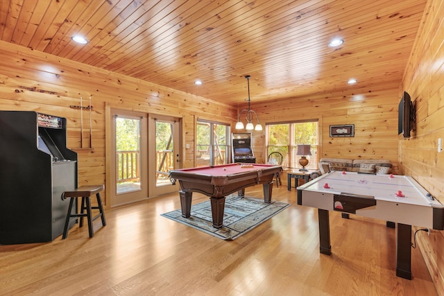 rec room with light wood finished floors, wooden walls, pool table, and wood ceiling