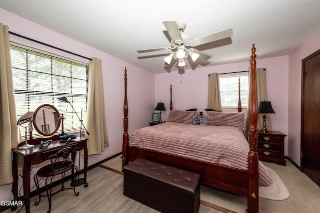 311 E Chestnut Hill Rd, Townsend, TN 37882 - bedroom with baseboards, a ceiling fan, light wood-style floors, and a textured ceiling