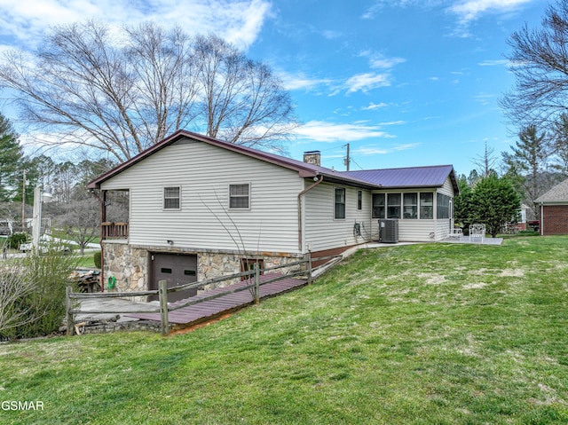 311 E Chestnut Hill Rd, Townsend, TN 37882 - back of property featuring a chimney, cooling unit, an attached garage, a sunroom, and a yard