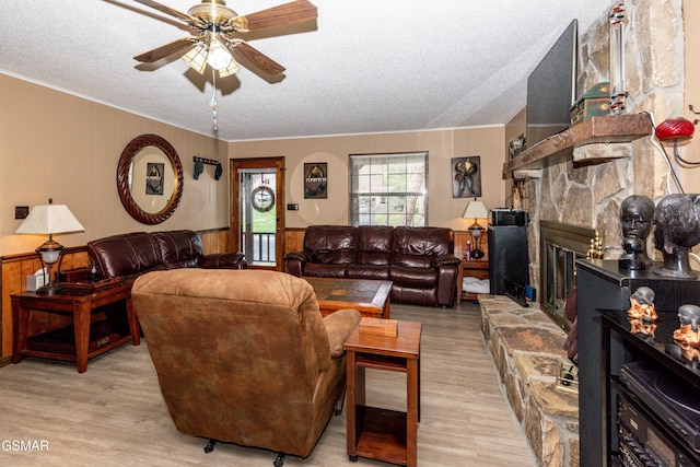 311 E Chestnut Hill Rd, Townsend, TN 37882 - living area featuring a ceiling fan, a fireplace, wood finished floors, a textured ceiling, and wainscoting