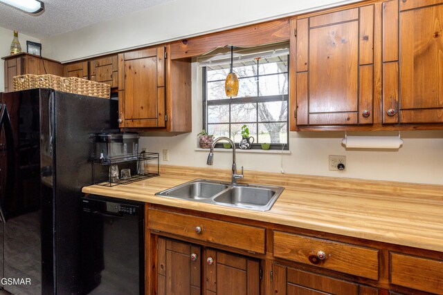 311 E Chestnut Hill Rd, Townsend, TN 37882 - kitchen featuring a textured ceiling, a sink, wood counters, black appliances, and brown cabinets