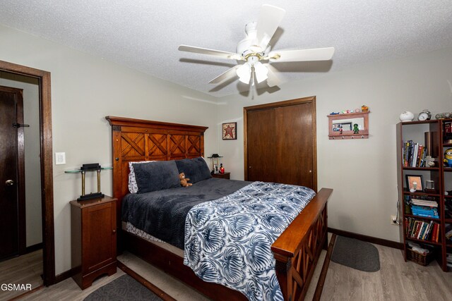 311 E Chestnut Hill Rd, Townsend, TN 37882 - bedroom featuring a closet, a textured ceiling, baseboards, and light wood finished floors