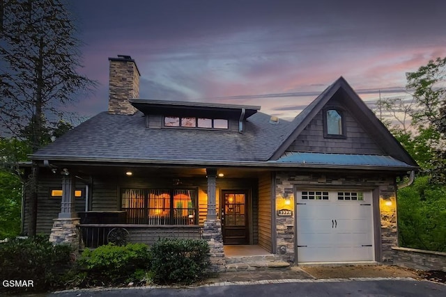 craftsman inspired home featuring a garage and covered porch