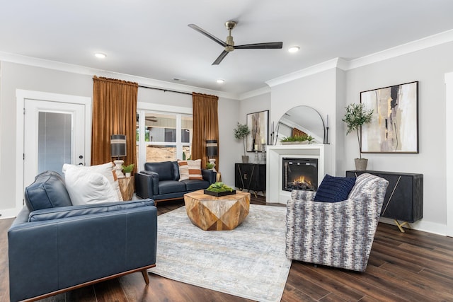 living room with ceiling fan, dark wood-type flooring, and crown molding