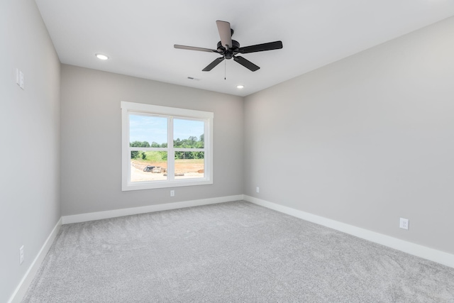 carpeted spare room featuring ceiling fan