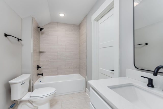 full bathroom with toilet, vanity, tiled shower / bath, and tile patterned flooring